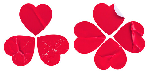 crushed and torn red heart-shaped stickers, arranged in two clover-like formations