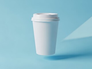 Minimalist white paper coffee cup mockup isolated on soft blue backdrop featuring clean design and bright lighting ideal for branding and product promotion