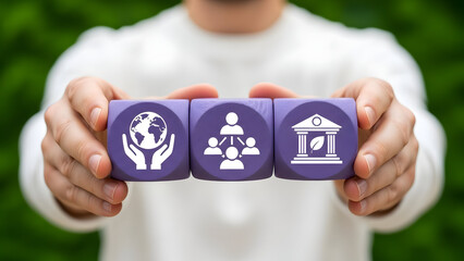 Person holding wooden blocks representing global connection, teamwork, and banking in a natural setting