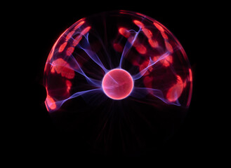 Plasma Ball with human hand causing plasma flow to jump to fingers creating unique patterns and textures