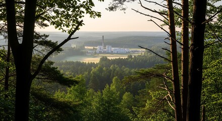 Obraz premium Sustainable Industrial Development Framed by Trees in a Lush Forest Landscape