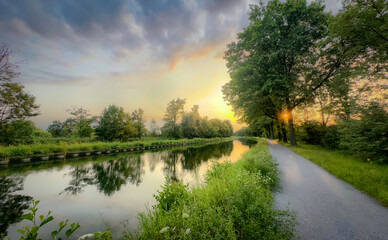 Experience the sereneness of a sunset by the tranquil canal your perfect nature escape awaits you