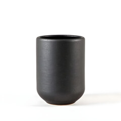 A black ceramic cup sits on a white background