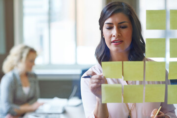 Woman, sticky note and glass wall in office for vision, business development and campaign planning. Creative team, brainstorming or moodboard in meeting for workflow, project management or set goals