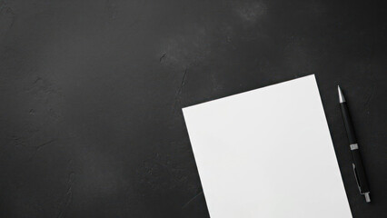 Blank paper and pen on dark background with copy space for banner design
