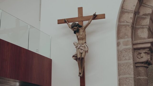 Crucifix statue displayed on interior church wall