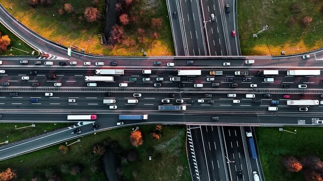 Busy city highway aerial view with cars and trucks moving in autumn