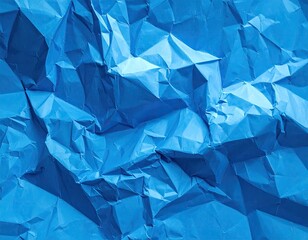 Close-up of intensely crumpled, vibrant blue paper, many folds, shadows