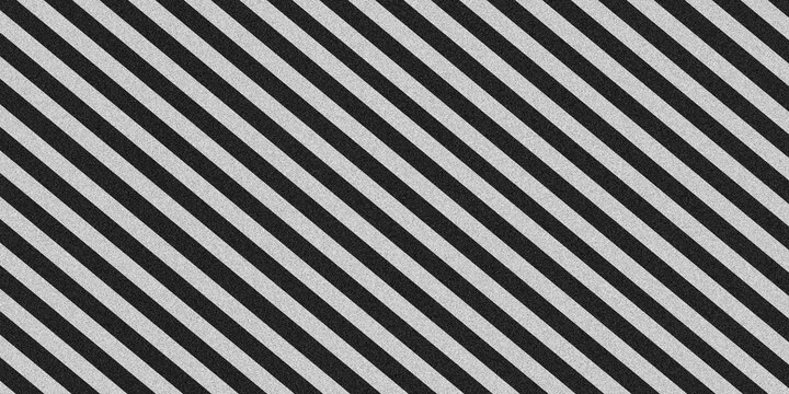 Diagonal black and white striped pattern background with grainy noise texture. Seamless repeat slanting lines backdrop for modern graphic design