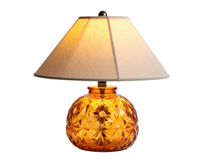 A table lamp with an amber-colored glass base, fabric shade, illuminated on a black background