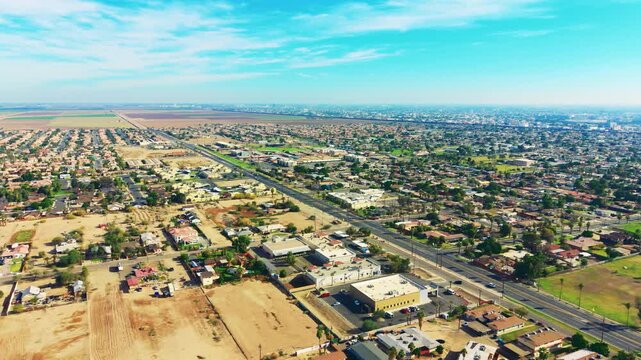 Aerial overview of Calexico, California, showing desert city grid, residential areas, streets, and border-town atmosphere under clear skies.