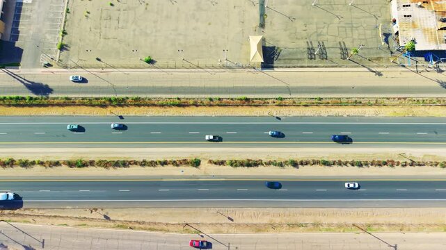 Aerial shot of freeway cutting through desert city landscape near Calexico, showcasing roads and transportation infrastructure.