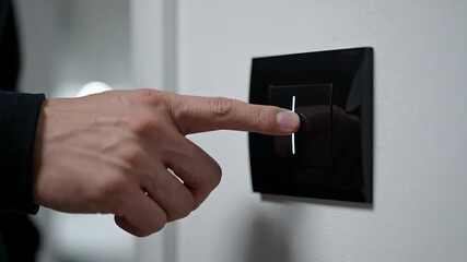 Close-up of modern black light switch on white wall with blurry light. - Powered by Adobe