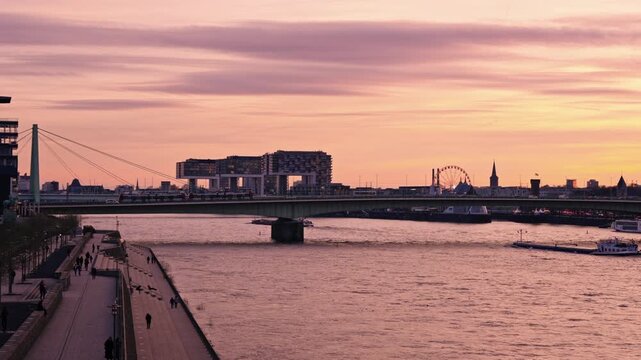 A wide sunset vista from the Rheinboulevard looking south toward the Rheinauhafen district. This view prominently features the Kranh&auml;user (Crane Houses).