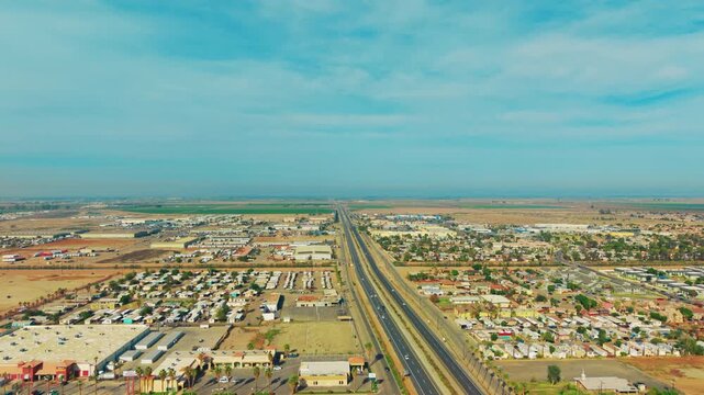 Aerial shot of a road through Calexico desert landscape highlighting isolation, infrastructure, and terrain.