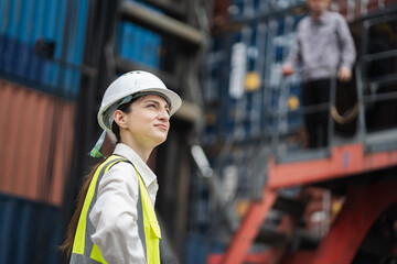 Caucasian woman logistics workers working with man worker at container site