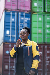 Portrait African woman logistics workers use walkie talkie checking container