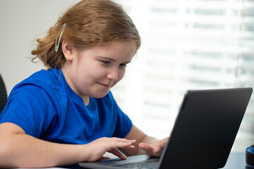 Digital school education for kids. Student writing in laptop for school. Child studying remote school. Student watching online school class.