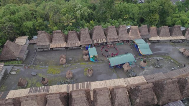 High angle aerial shot of people performing a traditional dance during the Reba festival in the megalithic Bena Village.
