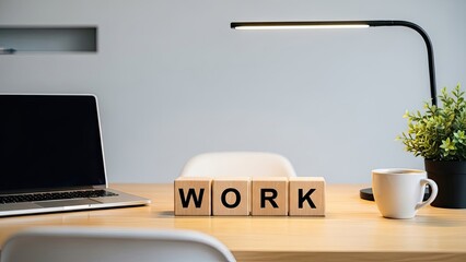 Work word blocks on modern desk with laptop and coffee mug