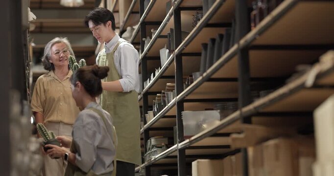 In a family business, a mother, son, and daughter manage a ceramic shop together, arranging tableware displays and coordinating daily operations for both retail and wholesale sales.

