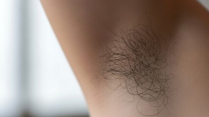 Close-up of Natural Human Armpit Hair on Smooth Skin