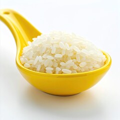 Close-up of white rice grains held in a bright yellow spoon, on white
