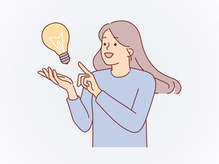 Happy Woman Pointing at Glowing Lightbulb Representing New Idea