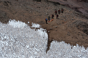 The movement of climbers in rows in extreme conditions on snowy, steep mountains