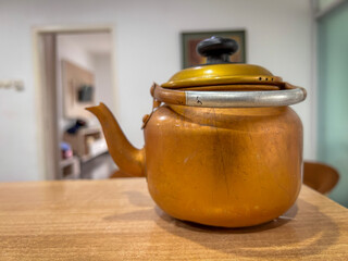 Traditional aluminum teapot with a gold-colored finish.