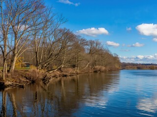 Fototapeta premium Calm riverbank under clear sky
