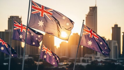 Australian flags fly against a golden sunset with city skyscrapers in the background
