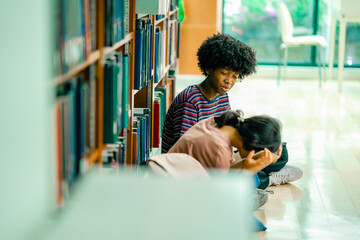 Library floor study scene with students reading books together, serious and stress emotion, worrie about exam, reflecting peer learning academic support knowledge exploration.