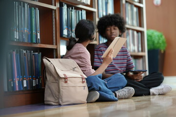 Students collaborating on study tasks inside library reflecting knowledge exchange academic growth education routine.