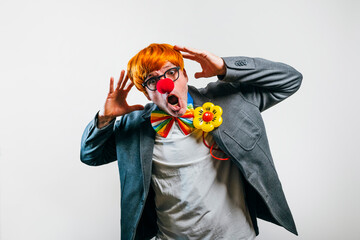 Funny clown making silly face with red nose
