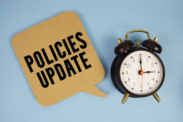 Policies Update text with alarm clock on blue background