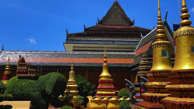 SIEMREAP, CAMBODIA - October 6, 2025: The interior of Wat Preah Prom Rath Temple. A Buddhist temple with statues of cows. A decorative structure made of gold. The main spiritual center of Siemreap. 4К