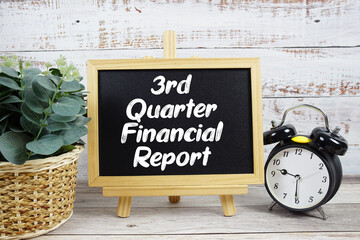 3rd Quarter Financial Reporttext written on blackboard with alarm clock on wooden background