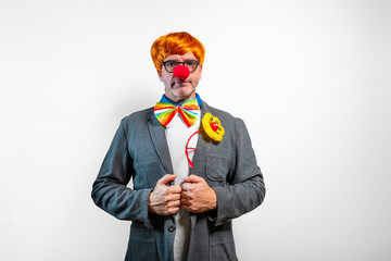 Clown with red nose and wig wearing serious expression