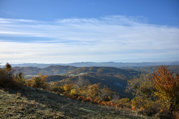Naklejka premium Autumn mountain landscape rocks stones clear day blue sky clouds walks tourism forest flora nature panorama