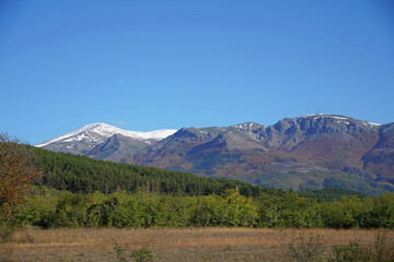 Fototapeta premium Autumn mountain landscape rocks stones clear day blue sky clouds snow top walk tourism forest flora nature panorama