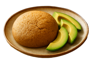 A delicious dish of jamaican bulla cake and avocado slices on plate, appetizing food