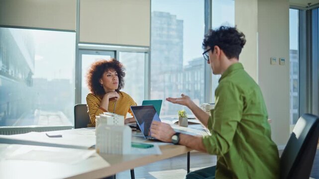 Real estate agents working in office space. Multiethnic colleagues discussing