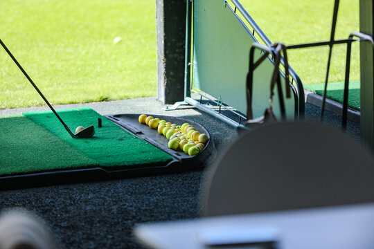 golf practice, a club and lots of balls