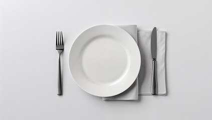 Minimalist overhead view showcasing a perfectly set formal dining place setting with a clean white plate fork and knife resting upon a soft gray textile napkin on a bright surface
