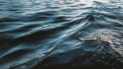 Close-up of deep blue ocean waves with sunlight reflections and ripples