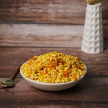 Traditional Indian street food bhel puri made with puffed rice, sev, chopped onions, tomatoes, potatoes, fresh coriander, and tangy tamarind and mint chutneys. Known for its crunchy texture and sweet,