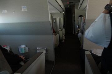 The aircraft's interior aisles contain overhead luggage compartments and passenger seating.
