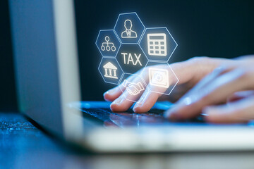 Hands typing on a laptop with digital tax and finance icons glowing above the keyboard in a modern workspace