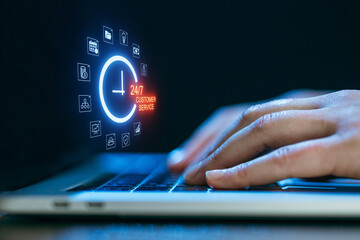 Hands typing on a laptop with a glowing 24/7 customer service icon displayed, conveying online support availability